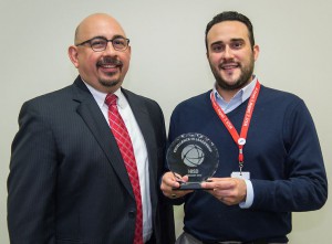 Chief of High Schools Michael Cardona presents Revere MS Principal Cristian de la Riva with the February Excellence in Leadership Award.