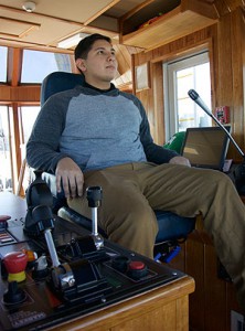 Austin HS junior Martin Delgado sits at the controls of the tugboat, ZEUS.