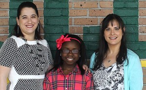 Shermya Parkere poses with Principal Rosa Hernandez (L) and teacher Olivia Holub
