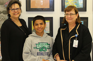 Grady MS seventh-grader Prabin Panta with HISD Curriculum Specialist Cynthia Gonzalez and Library Services Manager Liz Philippi. Photo courtesy Muses3, LLC.