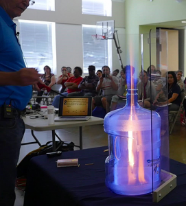 Greg Vogt demonstrates Newton's second law of motion by igniting vaporized ethanol to show how thrust is generated for rocket launches.